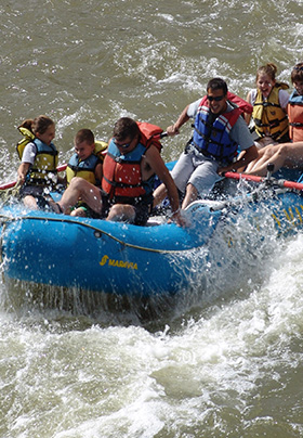 White-water rafting on the Rio Grande in a blue, rubber raft