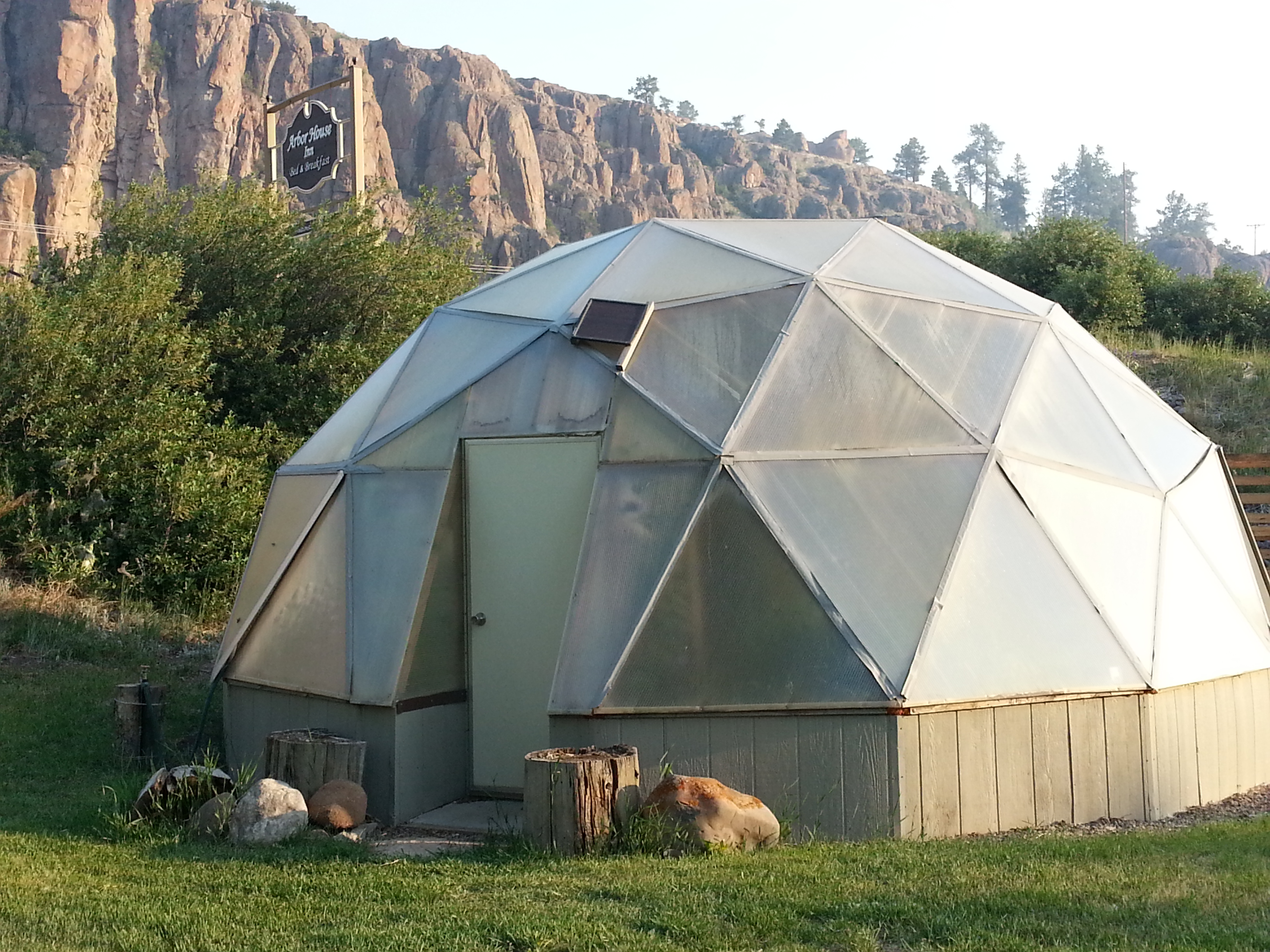 greenhouse dome in front of cliffs
