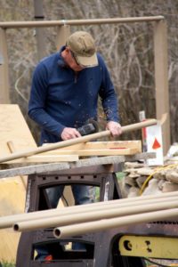 man in baseball cap welding 